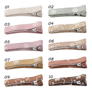 Set of 10 solid color embroidered cotton linen flower hair clips with daisy patterns