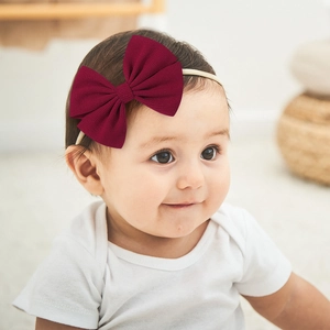 Soft burgundy waffle-knit baby bow headband with seamless high-elastic nylon band on infant