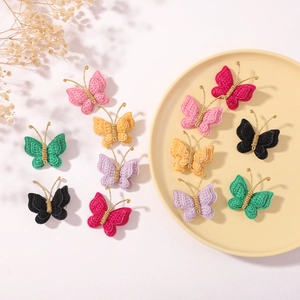 Handmade woven butterfly hair clips in vibrant colors including pink and green