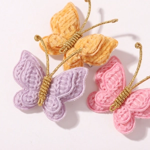 Handmade knitted butterfly hair clips in yellow, purple, and pink with gold wire accents