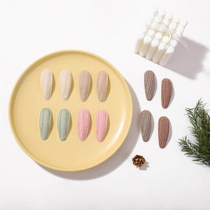Detailed close-up of 12-piece knitted teardrop hair clips in assorted Morandi candy colors