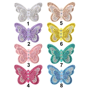 Tableau détaillé montrant huit couleurs de pinces à cheveux papillon avec des strass fins
