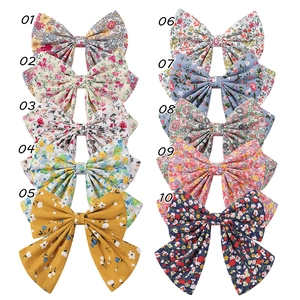 Set of 10 floral bow hair clips in diverse pastoral patterns and colors for girls