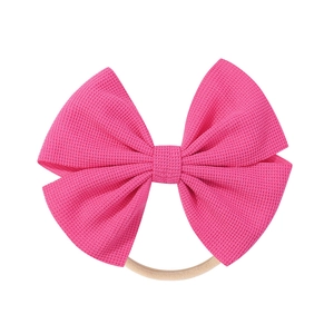 Detail of rose pink waffle fabric bow with high elasticity nylon band for infants