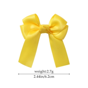 Cute bright yellow satin bow hair clip for girls with elegant ribbons and silky texture