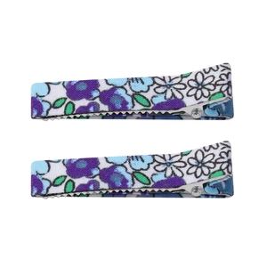 Detail view of two floral cotton fabric hair clips with alligator base in garden style