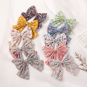 Floral print bow hair clips set for girls in various pastel colors and patterns