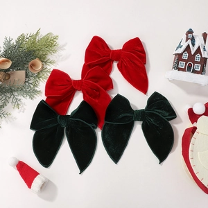 Retro velvet bow hair clips in red and dark green with festive Christmas styling accessories