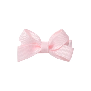 Detail of light pink grosgrain ribbon bow hair clip with fine texture and metal alligator clip