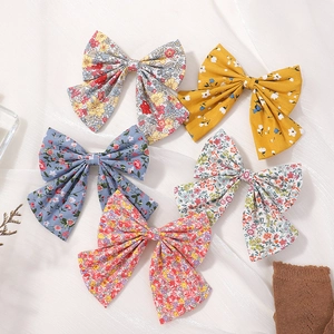 Set of 5 floral bow hair clips for girls in blue yellow and red colors with fabric texture