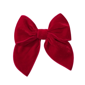 Detail view of a vintage deep red velvet double-layered bow hair clip for children