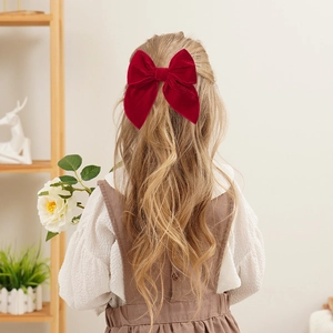 Vintage red velvet oversized bow hair clip for girls worn on long hair back view