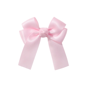 Detailed view of a pink satin bow hair clip with a smooth glossy finish and clean edges