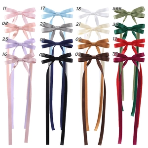 Grid view of various colorful satin bow hair clips with long streamers for girls