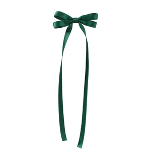 Detailed view of elegant dark green satin bow hair clip with long flowing tassels