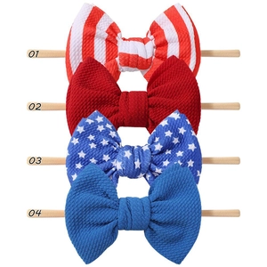 Detail view of 4-pack patriotic baby headbands with red stripes and white stars on bubble fabric