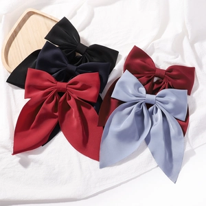 Large solid color satin bow hair clips in black, navy, red, and blue for women