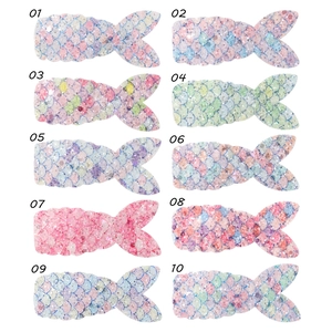 Detailed view of ten colorful sequin mermaid tail hair clips with scale textures