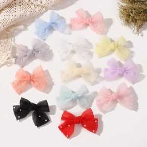 Vue détaillée de barrettes noeuds en tulle faites main avec perles et coloris variés