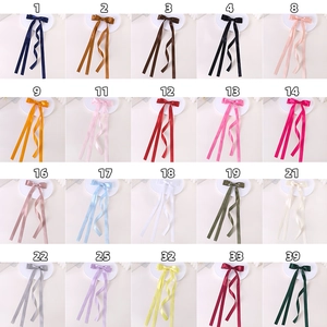 Detailed palette of twenty colorful satin ribbon hair clips with long streamers for girls