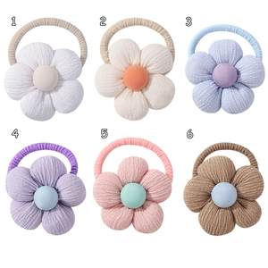 Detail view of cotton linen sunflower hair ties in six colorful 3D fabric designs