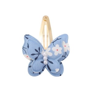Close-up of double-layer fabric butterfly hair clip with floral print and white pearls