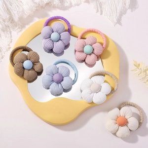 Handmade linen sunflower hair ties for girls in multiple pastel colors like lilac and blue