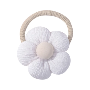 Detailed view of handmade cotton linen sunflower hair tie with 3D petal texture