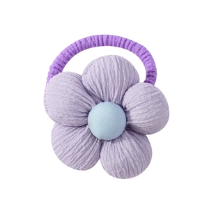 Detail of lavender corduroy flower hair tie with a light blue button center for girls