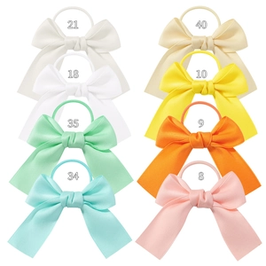 Detailed grid view of 8 colorful bow hair ties for children in various solid soft tones