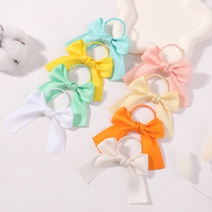 Set of 7 colorful grosgrain ribbon bow hair ties for girls in soft pastel spring colors