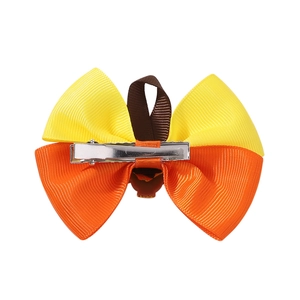 Detail showing the silver metal alligator clip on the back of the turkey hair bow accessory