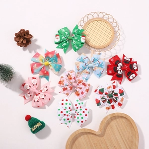 Set di fiocchi per capelli natalizi con motivi di Babbo Natale e renne su nastro canneté