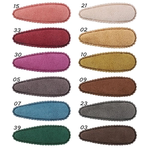 Close-up of 12 colors drop-shaped plush hair clips with wavy edges and wool texture
