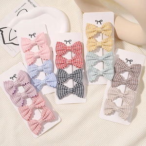 Gingham checkered bow hair clips set for girls in multiple colors on a cream background