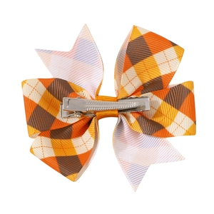 Detailed view of the silver metal duckbill clip on the plaid ribbon hair bow