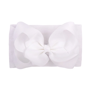 Detailed close-up of white soft nylon baby headband featuring a large grosgrain ribbon bow