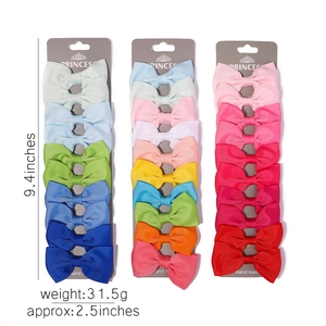 Detailed size view of colorful grosgrain ribbon hair bows on three display cards