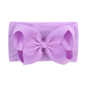 Detailed view of soft purple nylon baby headband with a large textured jacquard bow