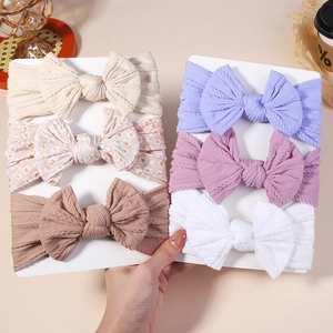 Vue détaillée de 6 bandeaux bébé en tissu jacquard élastique avec de grands nœuds