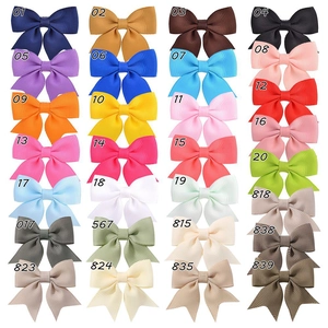Grid display of 24 colorful grosgrain ribbon bow hair clips with swallowtail design