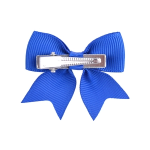 Detail view of royal blue grosgrain ribbon bow with a silver metal alligator clip base