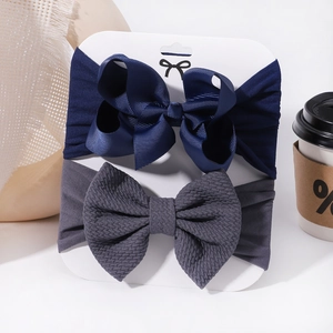 Detail of baby headband set featuring navy grosgrain bow and grey waffle fabric textures
