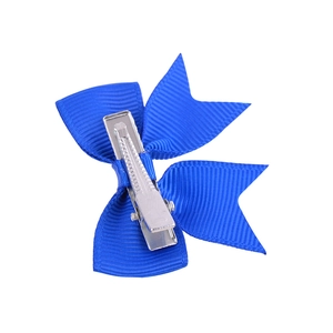 Detailed view of dark blue grosgrain ribbon bow with a silver metal alligator clip