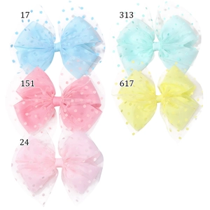 Detail showing five colors of double-layered mesh bow hair clips with polka dots