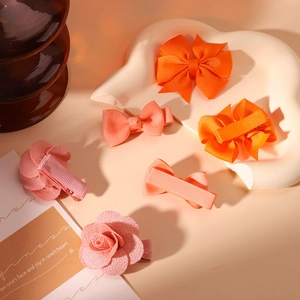 Handmade fabric hair bow set with floral clips for girls in a soft warm aesthetic scene