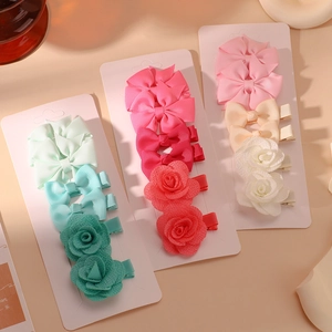 Detail of assorted handmade ribbon bow and fabric flower hair clips on display cards