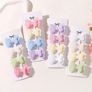 Detailed close-up of colorful butterfly hair clips made of textured cotton and linen fabrics