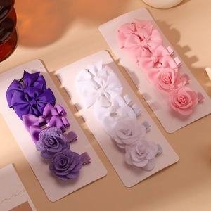 12-piece girls' hair bow and fabric rose clip set in purple, white, and pink tones