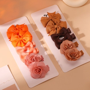 Detail of handmade fabric hair bow clips and glitter mesh rose flowers for girls